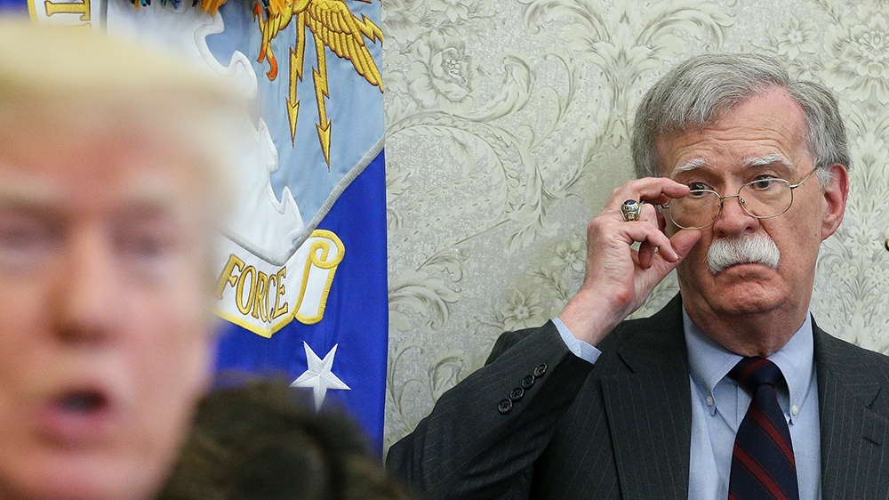 President Donald J. Trump (L) speaks as National security advisor John Bolton (R) listens during a meeting with South Korean President Moon Jae-in, in the Oval Office of the White House in Washington