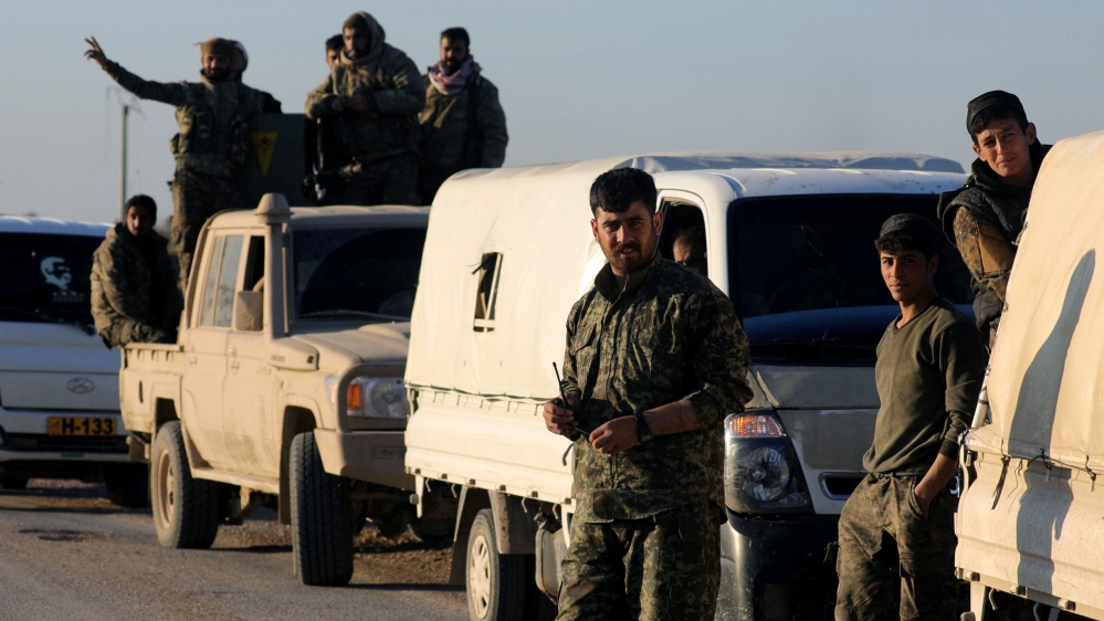 Fighters from the Syrian Democratic Forces (SDF) are pictured together near the village of Baghouz, Deir Al Zor province