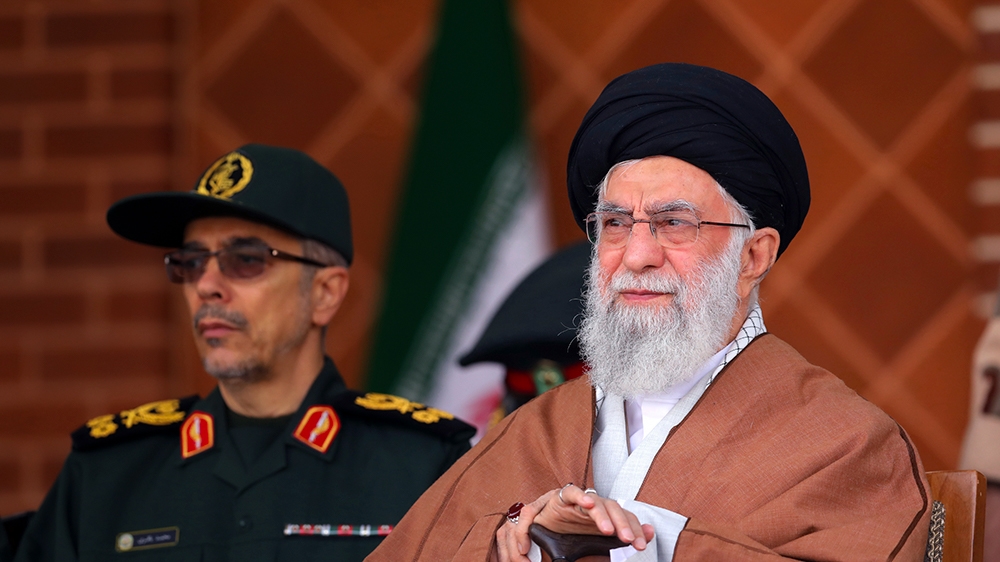 In this picture released by an official website of the office of the Iranian supreme leader, Supreme Leader Ayatollah Ali Khamenei, right, reviews armed forces with Chief of the General Staff of the A