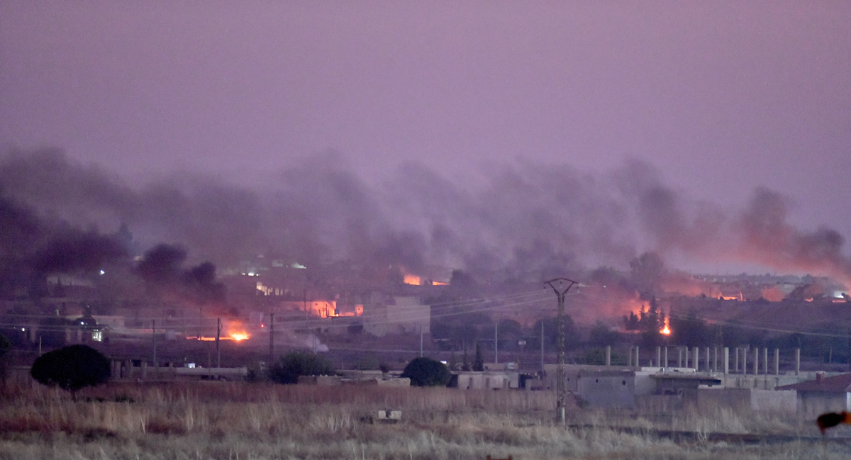 SANLIURFA, TURKEY - OCTOBER 09: A photo taken from Turkey''s Sanliurfa province, on October 09, 2019 shows smoke rises at the site of Ras al-Ayn city of Syria after terrorists burn tires to avoid being