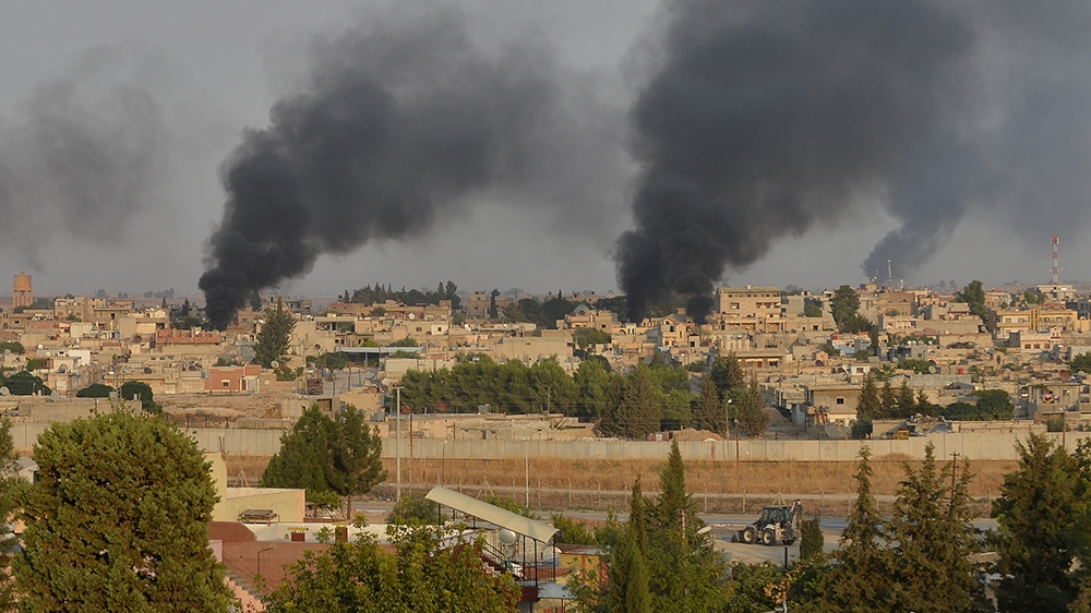 Smoke rises from the Syrian border town of Ras al-Ain as it is pictured from the Turkish town of Ceylanpinar in Sanliurfa province, Turkey, October 9, 2019. REUTERS/Stringer NO RESALES. NO ARCHIVES T