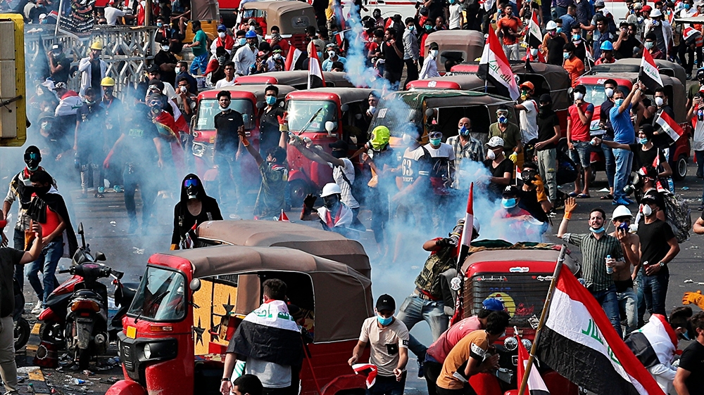 Iraqi security forces fire tear gas to disperse Anti-government protesters during a demonstration in Baghdad, Iraq, Tuesday, Oct. 29, 2019. (AP Photo/Khalid Mohammed)