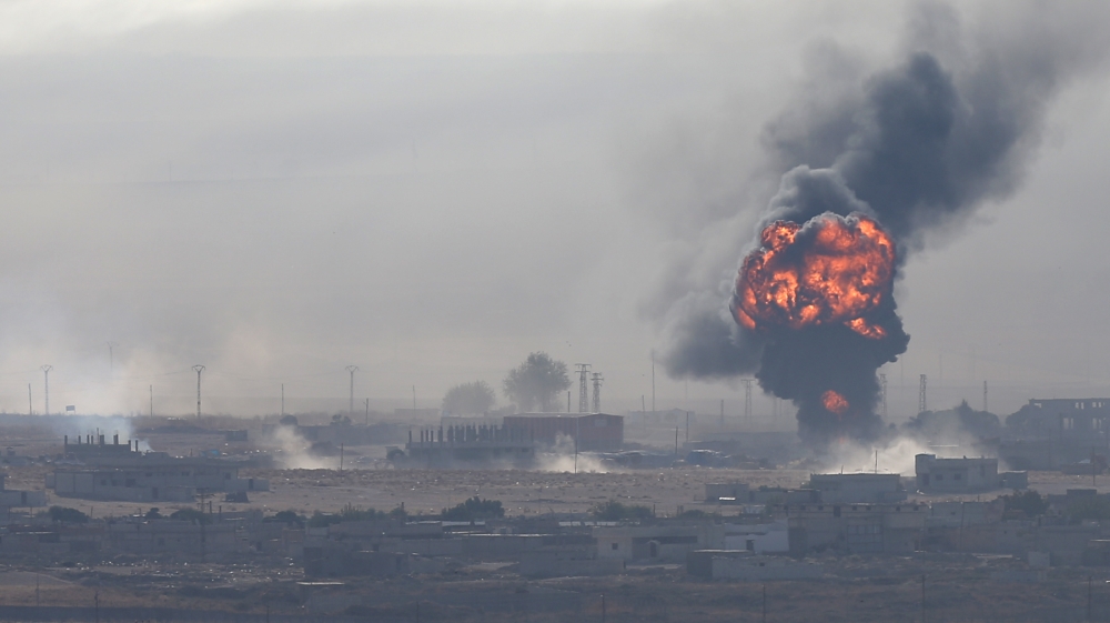An explosion is seen over the Syrian town of Ras al-Ain as seen from the Turkish border town of Ceylanpinar, Sanliurfa province, Turkey, October 12, 2019.