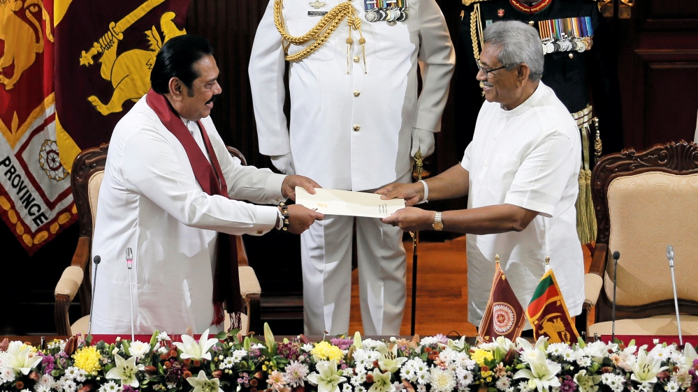 Sri Lanka''s President Gotabaya Rajapaksa hands over a document to his brother and former leader Mahinda Rajapaksa, who was appointed as the new Prime Minister