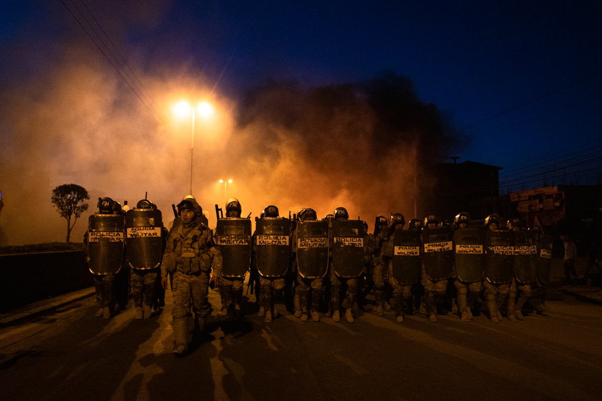 Antiriot police move towards the site where protesters and supporters of Evo Morales have camped since the president’s resignation on November 10, 2019. Over 3,000 rural supporters of the ousted presi