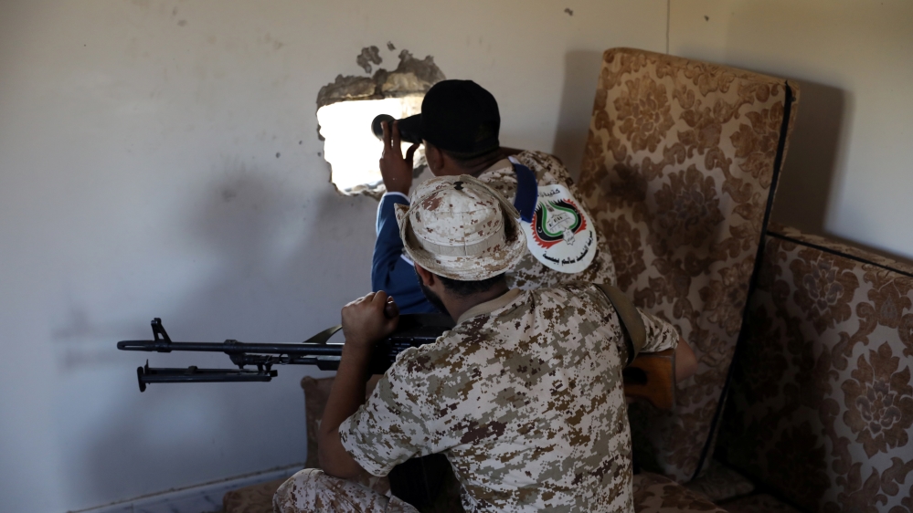 Members of the Libyan internationally recognised government forces take their positions in Ain Zara