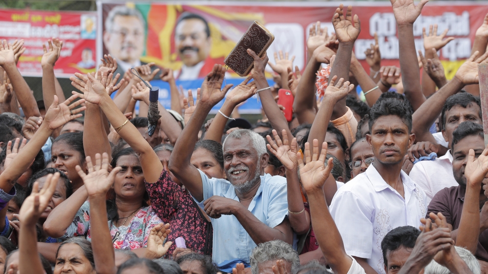 Supporters of Sri Lankan presidential candidate and former defense chief Gotabaya Rajapaksa cheer during a rally in Neluwa village in Galle, Sri Lanka, Tuesday, Oct. 22, 2019. Rajapaksa is the front-r