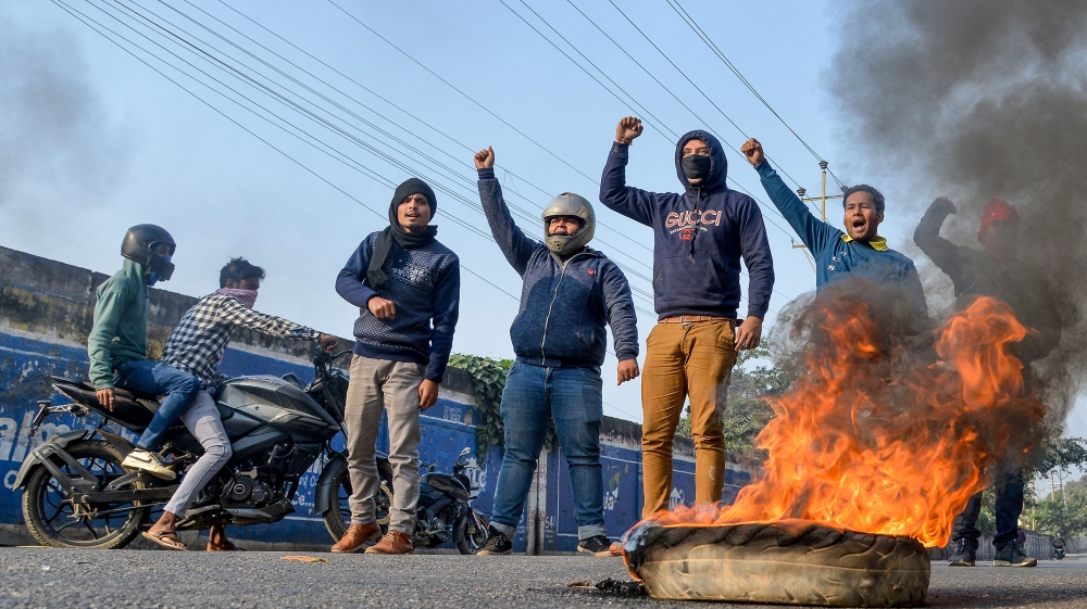 Protesters shout slogans as they burn tyres on a road during the strike called by North East Students'' Organization (NESO) against the government''s Citizenship Amendment Bill (CAB), in Guwahati on Dec