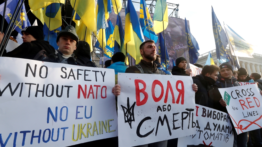 People take part in a rally ahead of the so-called "Normandy" format summit, in Kiev