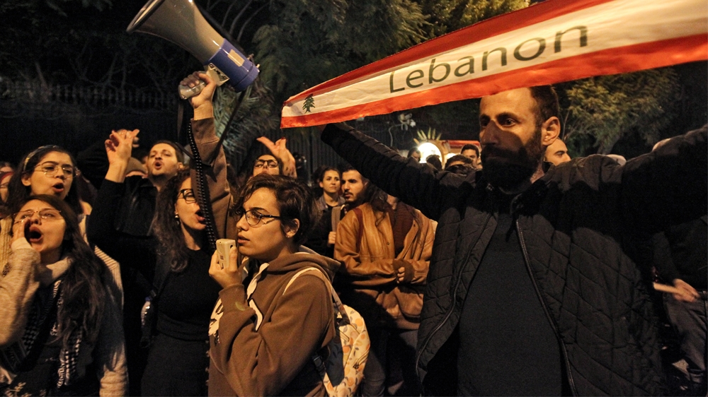 LEBANON-POLITICS-DEMO Protesters chant slogans as they march during a demonstration outside the Interior Ministry headquarters in the Lebanese capital Beirut on December 11, 2019. IBRAHIM AMRO / AFP