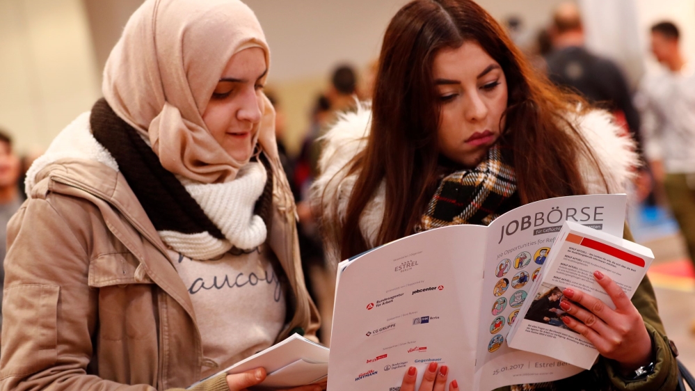 Two women visit the second job fair for migrants