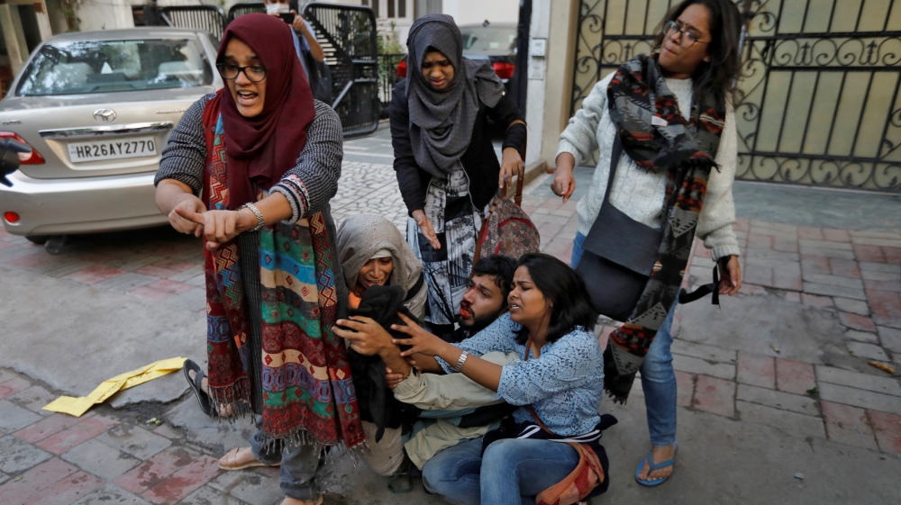 Demonstrators react during a protest against a new citizenship law, in New Delhi, India, December 15, 2019. REUTERS/Adnan Abidi