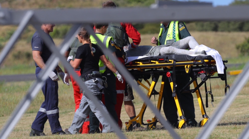 Emergency services attend to an injured person arriving at the Whakatane Airfield after the volcanic eruption Monday, Dec. 9, 2019, on White Island, New Zealand. (Alan Gibson/New Zealand Herald via AP