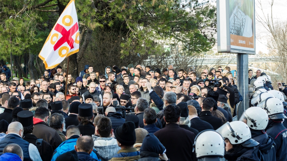Serbian Orthodox Church clergy and believers hold a service on a bridge near the parliament,