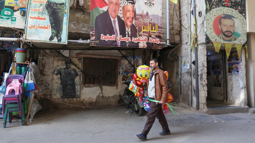 A man walks as he sells air balloons at Burj al-Barajneh refugee camp in Beirut