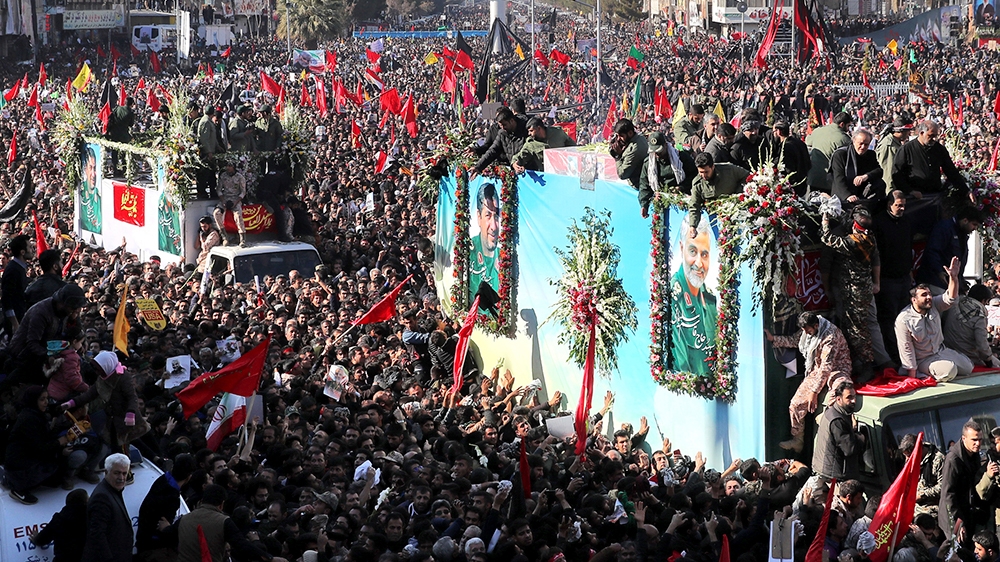 Coffins of Gen. Qassem Soleimani and others who were killed in Iraq by a U.S. drone strike, are carried on a truck surrounded by mourners during a funeral procession, in the city of Kerman, Iran, Tues