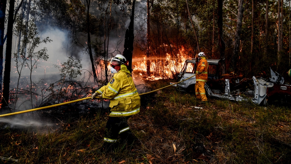 Rural Fire Service (RFS) firefighters conduct property protection near the town of Sussex Inlet on December 31, 2019 in Sydney, Australia. There are a number of dangerous bushfires burning at emergenc