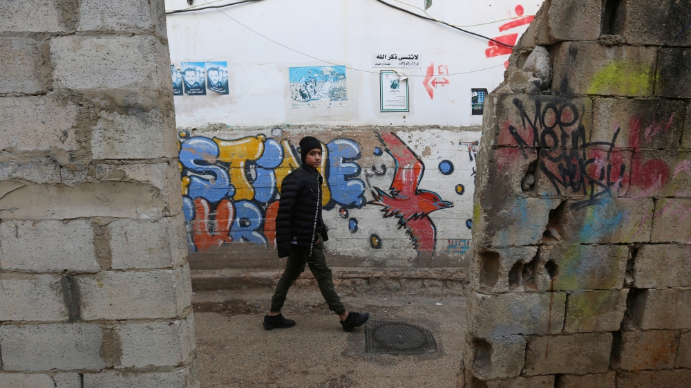 A boy walks along a street at Burj al-Barajneh refugee camp in Beirut