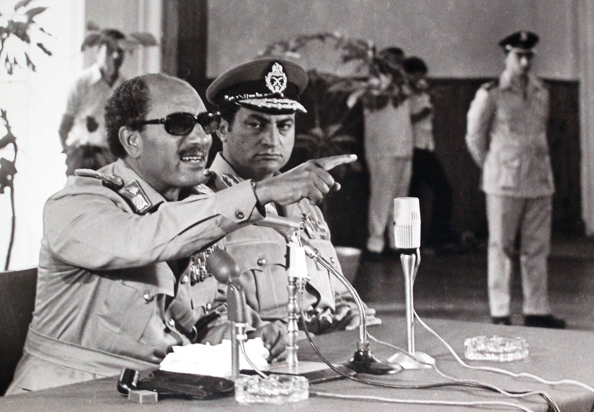 In this undated photo taken in 1979, Egypt''s President Anwar Sadat, left, makes remarks as Vice President Hosni Mubarak, center, looks on in Cairo, Egypt. (AP Photo/Farouk Ibrahim)
