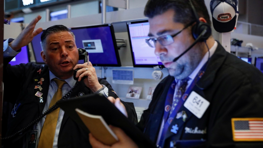 Traders work on the floor at the NYSE in New York