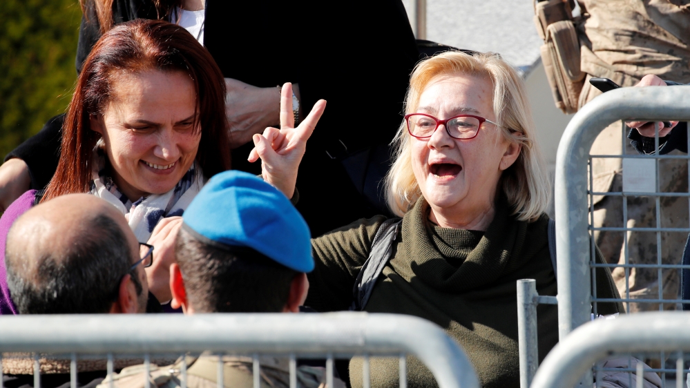 Mucella Yapici, who is one of the 16 defendants acquitted over their alleged role in Turkey''s Gezi Park protests case, gestures after leaving a courtroom at the Silivri Prison and Courthouse complex