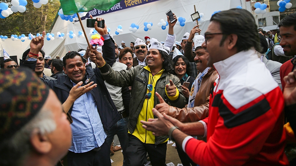 Supporters of the Aam Aadmi Party, or "common man''s" party, celebrate as initial results show the party in the lead, at their party office in New Delhi, India, Tuesday, Feb. 11, 2020. The polls put I