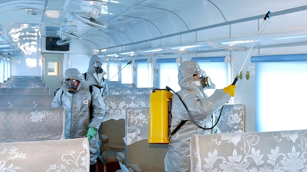 This undated picture released from North Korea''s official Korean Central News Agency (KCNA) on February 15, 2020 shows people in protective suits spraying disinfectant at an undisclosed location in No