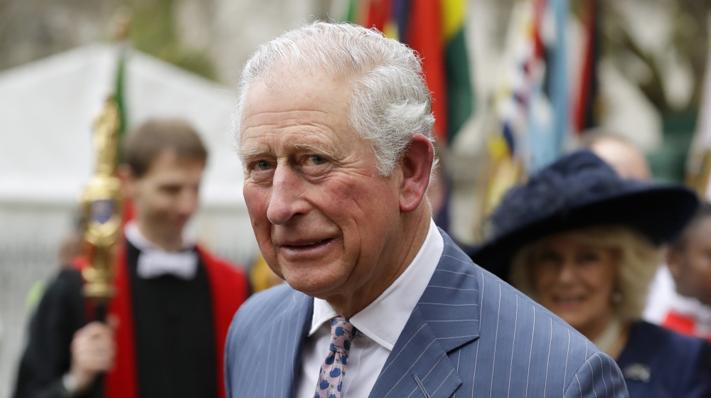 Britain's Prince Charles and Camilla the Duchess of Cornwall, in the background, leave after attending the annual Commonwealth Day service at Westminster Abbey in London, Monday, March 9, 2020. The an