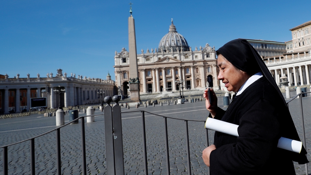 A nun walks past deserted St. Peter's Square after a decree orders for the whole of Italy to be on lockdown in an unprecedented clampdown aimed at beating the coronavirus, in Rome