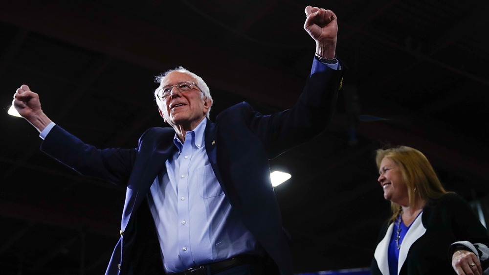 Democratic presidential candidate Sen. Bernie Sanders, I-Vt., accompanied by his wife Jane O’Meara Sanders, speaks during a primary night election rally in Essex Junction, Vt., Tuesday, March 3, 2020.