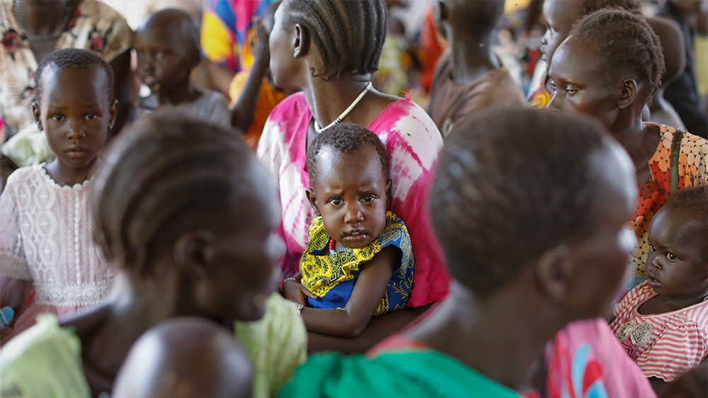 epa07742390 A young South Sudanese refugee boy is held by his mother as the await for their turn during a health checkup in Kakuma Refugee Camp, Turkana county, northern Kenya, 25 June 2019. Despite a