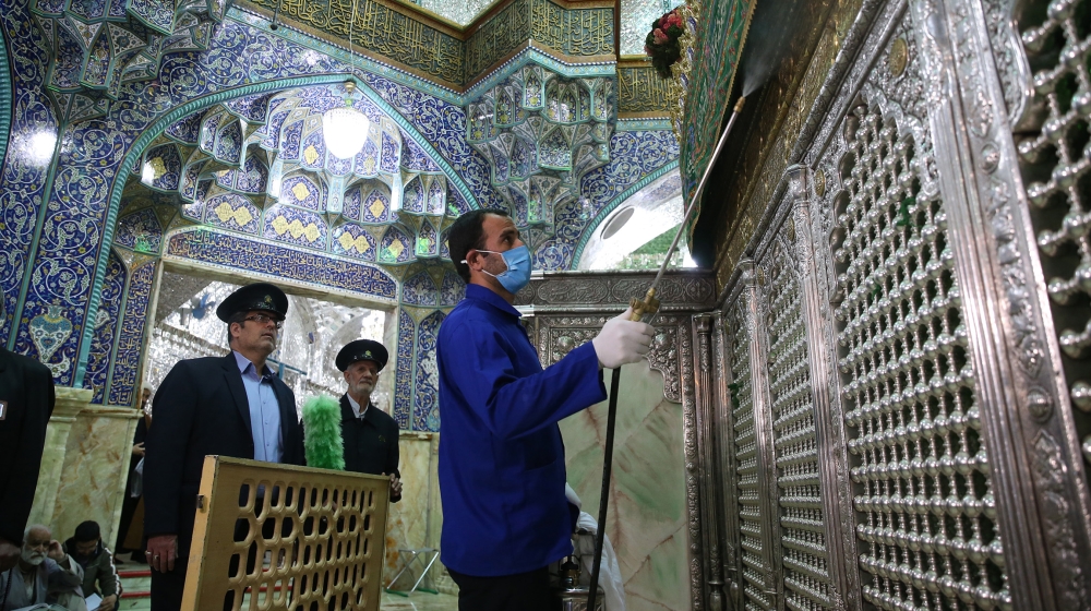 FILES) In this file photo taken on February 25, 2020, an Iranian sanitary workers disinfect Qom''s Masumeh shrine to prevent the spread of the coronavirus which reached Iran, where there were concerns