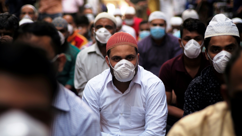 Muslims wear protective face masks following the coronavirus outbreak, as they pray on street during Friday prayers in local souq, in Manama