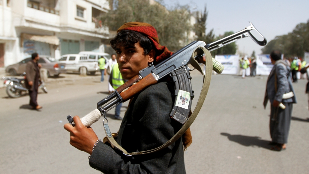 FILE PHOTO: A Houthi supporter looks on as he carries a weapon during a gathering in Sanaa