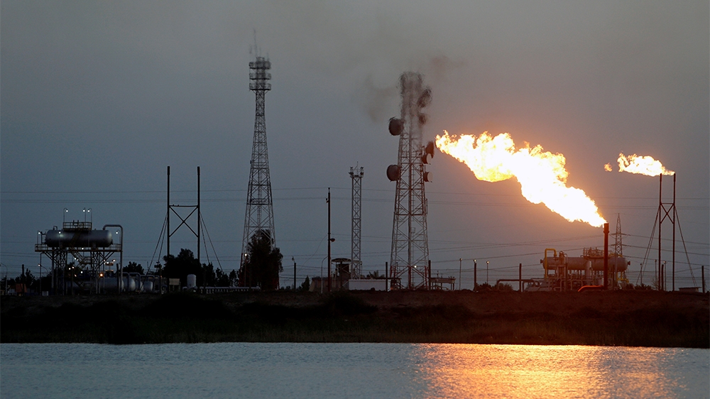FILE PHOTO: Flames emerge from flare stacks at Nahr Bin Umar oil field, north of Basra, Iraq March 9, 2020. REUTERS/Essam Al-Sudani/File Photo