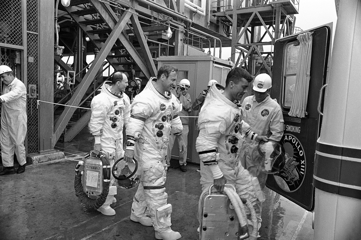 Members of the Apollo 13 crew leave the launch site after finishing a count down demonstration in the Apollo 13 spaceship, March 26, 1970 at Cape Kennedy in Florida. Leading the astronauts is Fred W.