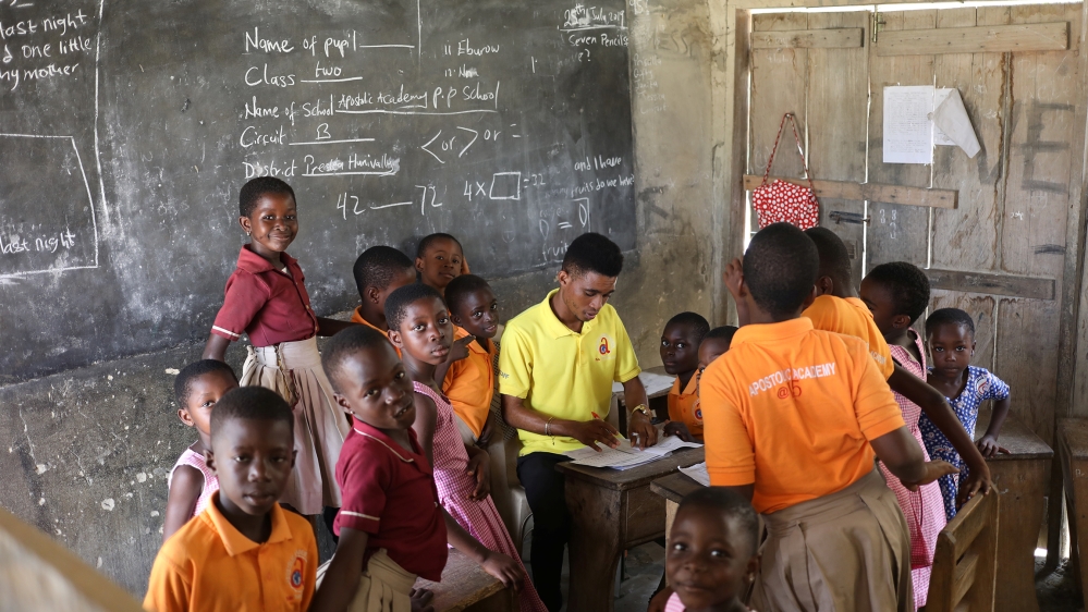 School children gather around their teacher in class in Prestea, a mining town in southwest Ghana, July 25, 2019. REUTERS/Siphiwe Sibeko