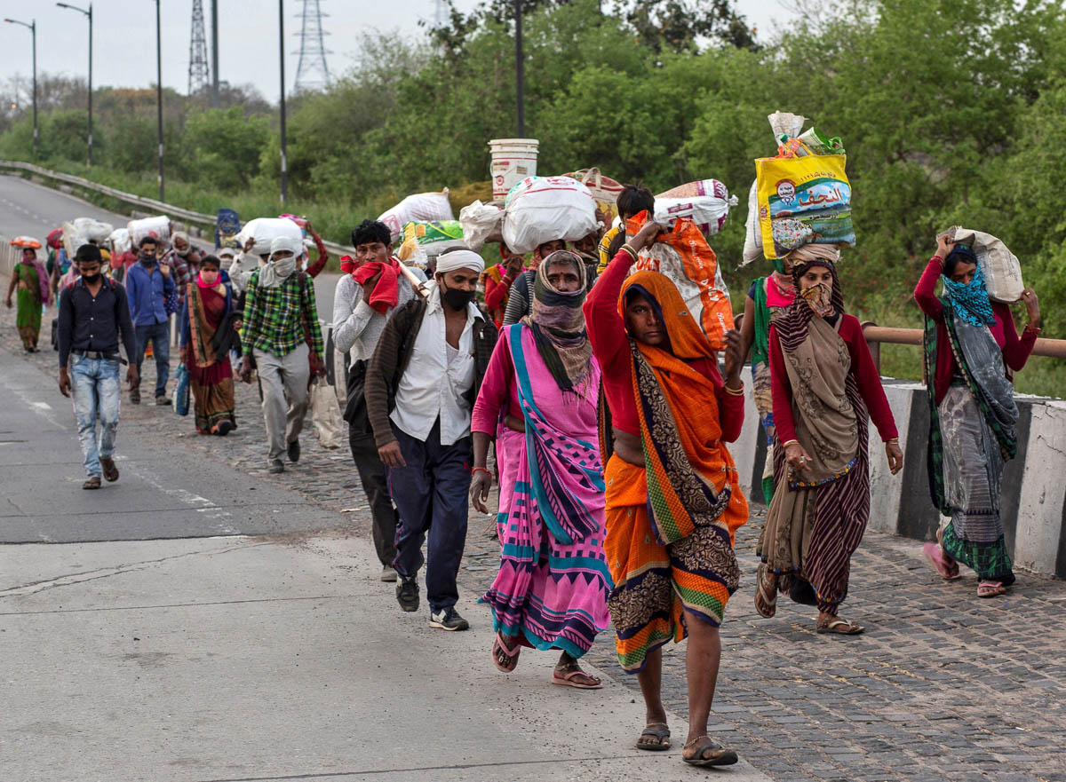 Friends and relatives of Kushwaha family who work as migrant workers walk along a road to return to their villages, during a 21-day nationwide lockdown to limit the spreading of coronavirus, in New De