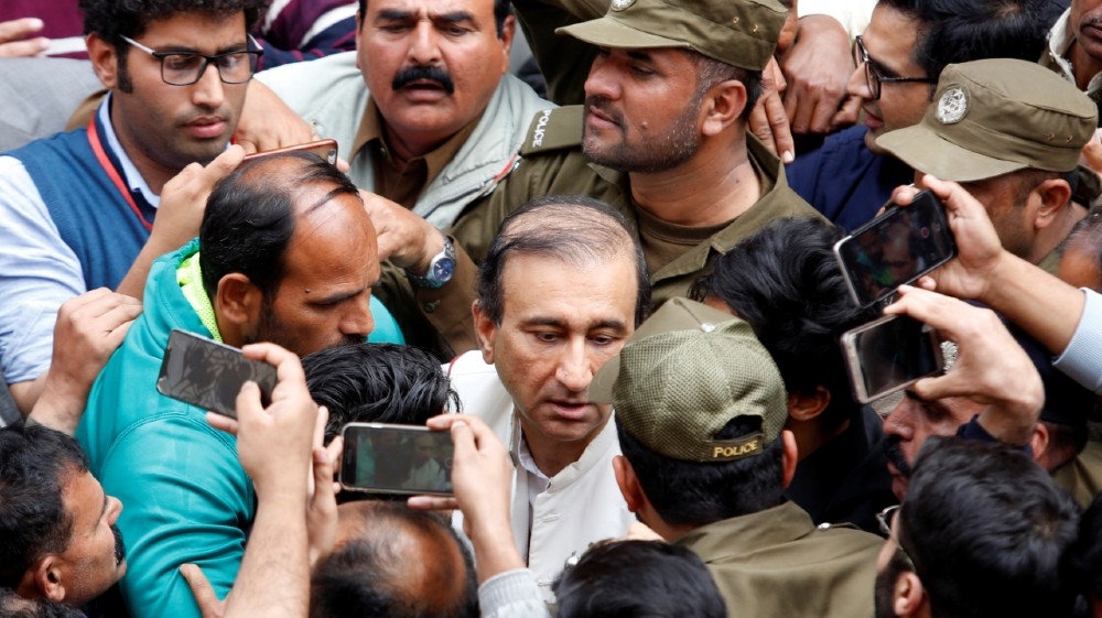 Police officers and media persons gather as Mir Shakil-ur-Rehman, th