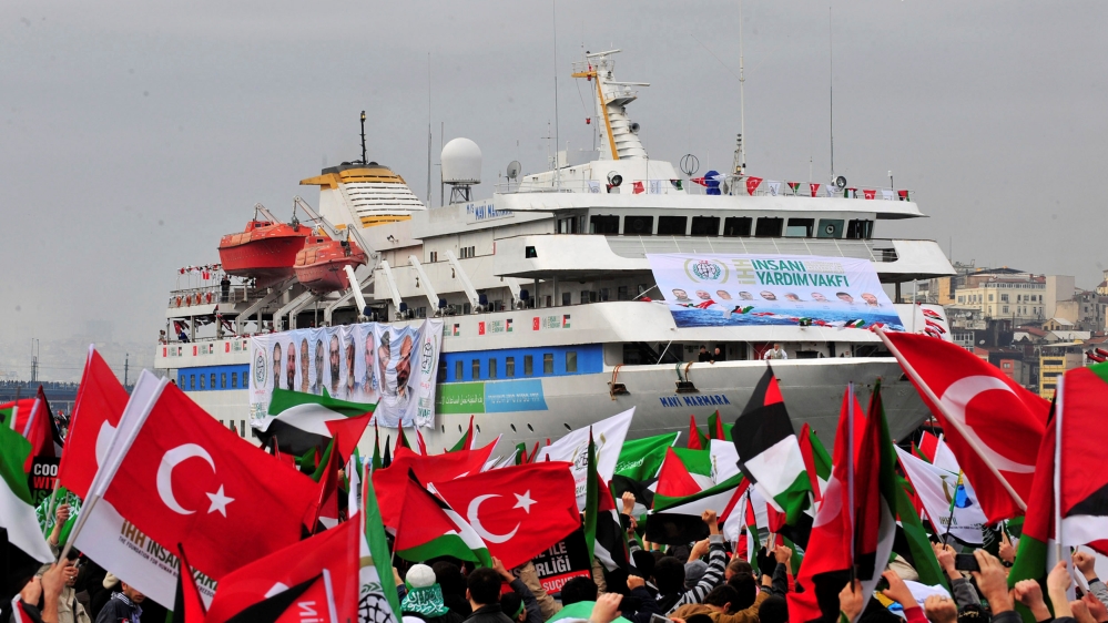 Pro-Palestinian activists wave Turkish and Palestinian flags during the welcoming ceremony for cruise liner Mavi Marmara at the Sarayburnu port of Istanbul