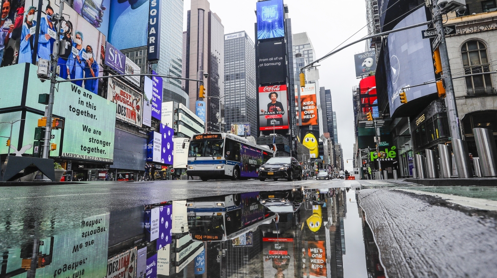 Vehicles move through a nearly empty Times Square during the coronavirus pandemic, Saturday, May 23, 2020, in New York. (AP Photo/Frank Franklin II)