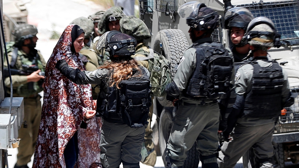 A Palestinian woman cries as she is stopped by Israeli forces after an Israeli soldier was killed by a rock thrown during an arrest raid, in Yabad near Jenin in the Israeli-occupied West Bank May 12,