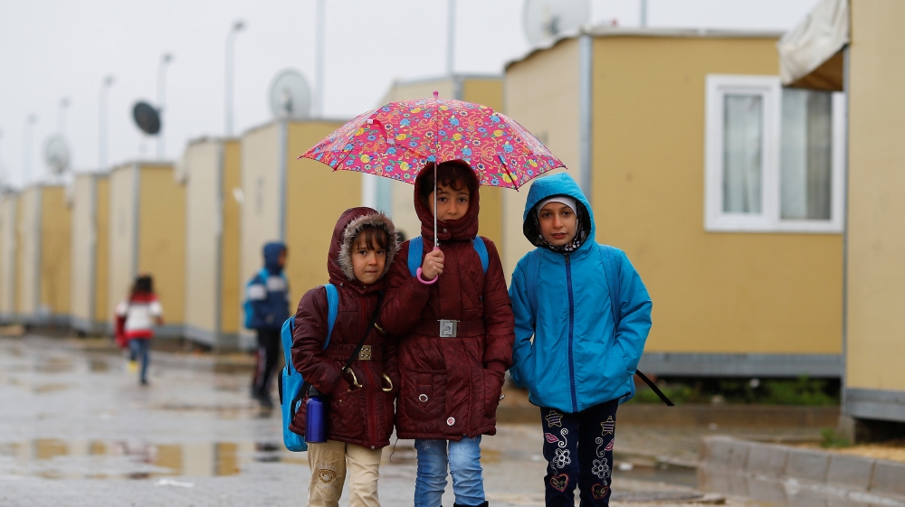 Syrian refugee children walk in Elbeyli refugee camp