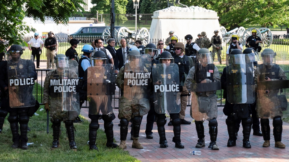 U.S. Attorney General Bill Barr confers with U.S. Secret Service and other officials in the center of Lafayette Park shortly before riot police cleared the park and the surrounding area across from th