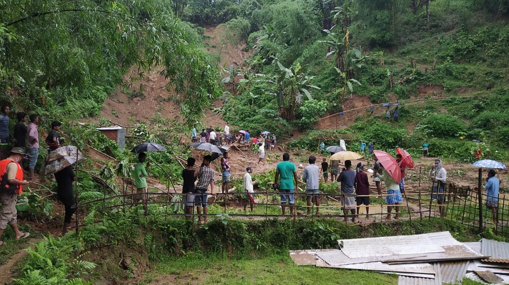 People gather at the site of a landslide in Udarband village, Cachar district in the Barak Valley of southern Assam state on June 2, 2020. At least 20 villagers, including 10 children, were killed in