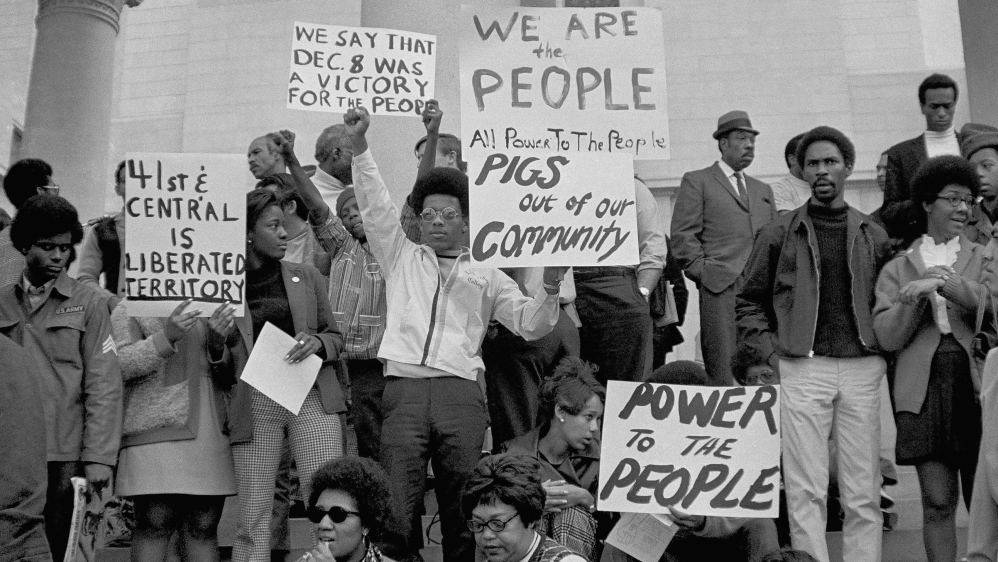 Demonstrators mass on the steps of the Los Angeles City Hall