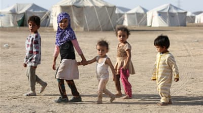 Children walk at a camp for people recently displaced by fighting in Yemen's northern province of al-Jawf between government forces and Houthis, in Marib