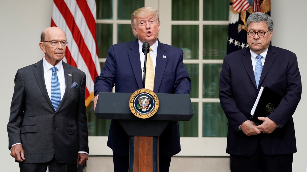U.S. President Donald Trump stands between Commerce Secretary Wilbur Ross and Attorney General Bill Barr to announce his administration''s effort to gain citizenship data during the 2020 census at an e