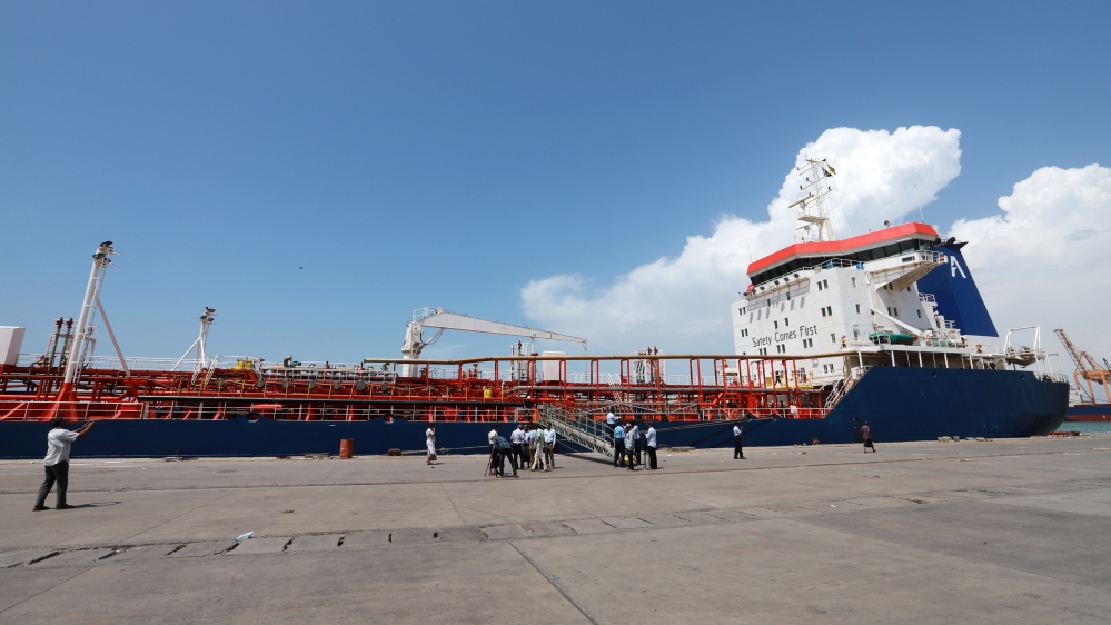 Workers prepare to unload a fuel shipment in Yemen.