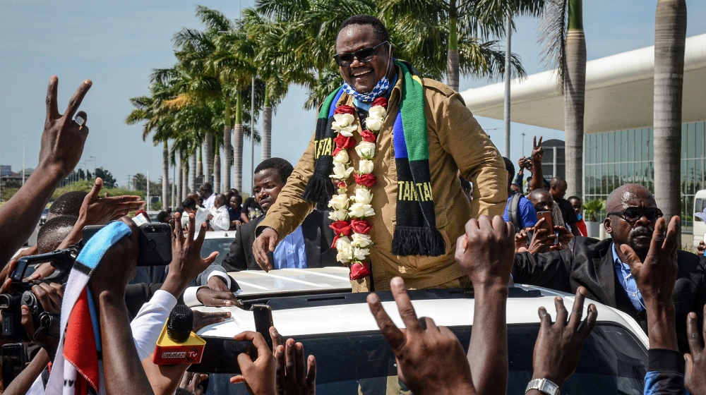 Tundu Lissu (C), Tanzania''s former MP with the Chadema main opposition party, who was shot 16 times in a 2017 attack, reacts to supporters as he returns after three years in exile to challenge Preside